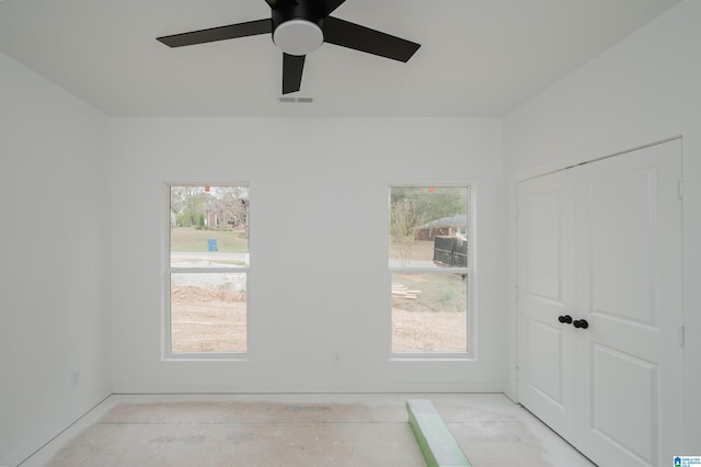 interior space with ceiling fan