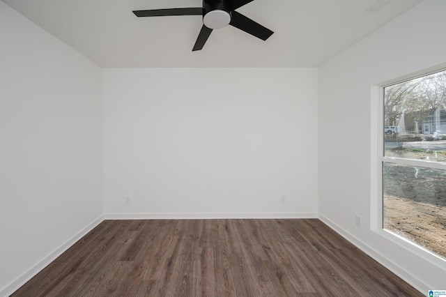 spare room featuring ceiling fan, dark hardwood / wood-style flooring, and a healthy amount of sunlight