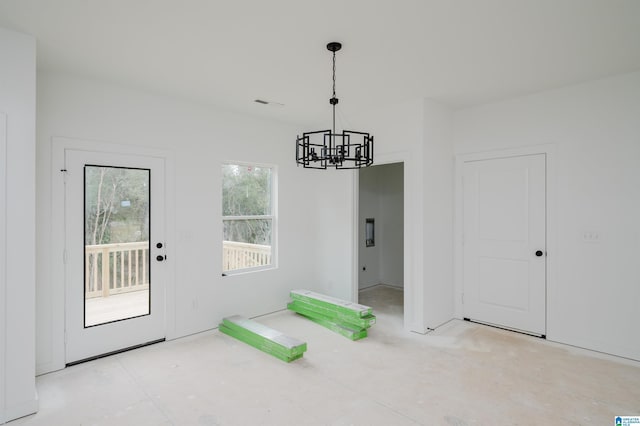 unfurnished dining area with a notable chandelier