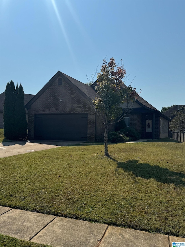 single story home with a garage and a front lawn