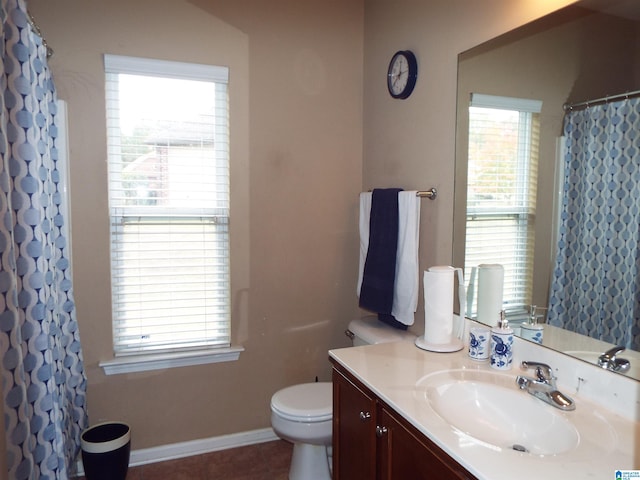 bathroom with vanity, tile patterned floors, toilet, and plenty of natural light