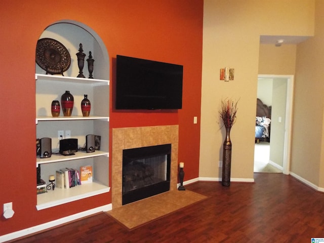 living room with a fireplace and dark hardwood / wood-style floors