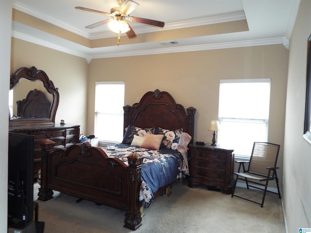 bedroom featuring crown molding, ceiling fan, light colored carpet, and a raised ceiling