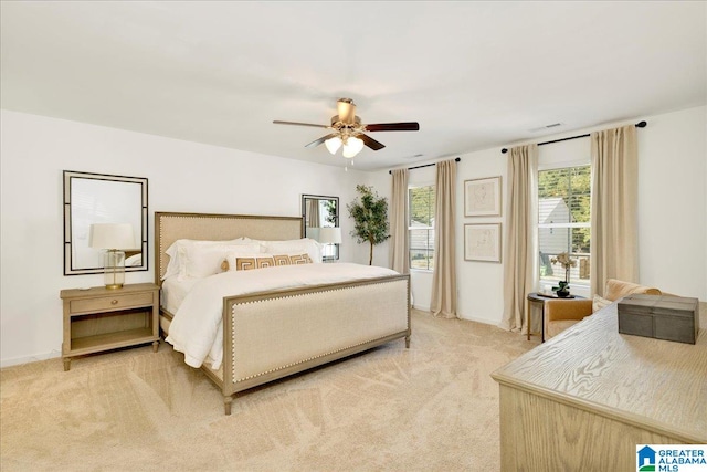 bedroom featuring ceiling fan and light carpet