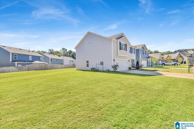 view of side of property with a yard and a garage