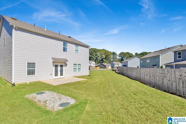 back of house featuring a yard and a patio