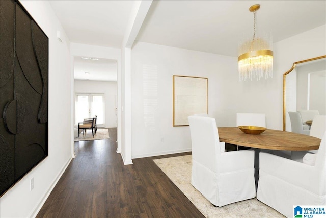 unfurnished dining area featuring an inviting chandelier, beamed ceiling, and hardwood / wood-style flooring