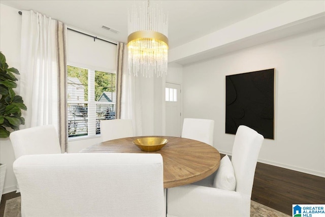 dining space featuring a notable chandelier and dark wood-type flooring