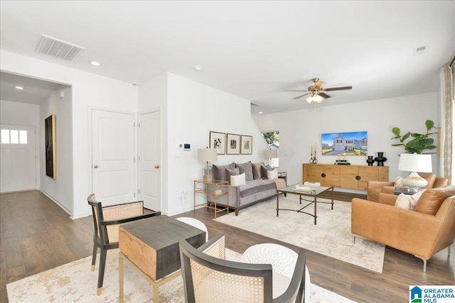 living room featuring ceiling fan and hardwood / wood-style flooring