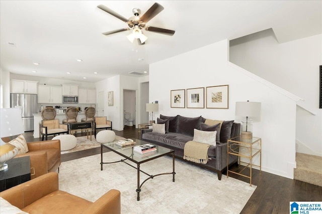 living room featuring hardwood / wood-style floors and ceiling fan