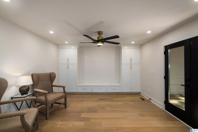 sitting room featuring light hardwood / wood-style flooring and ceiling fan