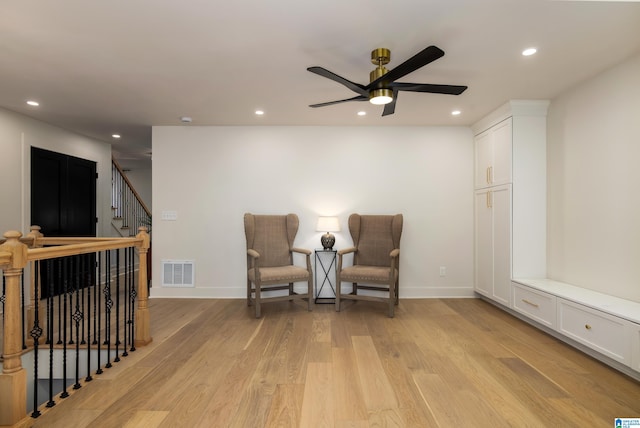 sitting room with ceiling fan and light hardwood / wood-style floors