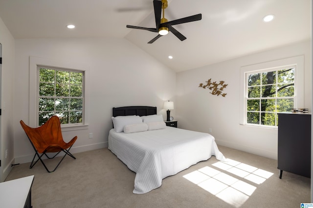 carpeted bedroom with lofted ceiling, multiple windows, and ceiling fan