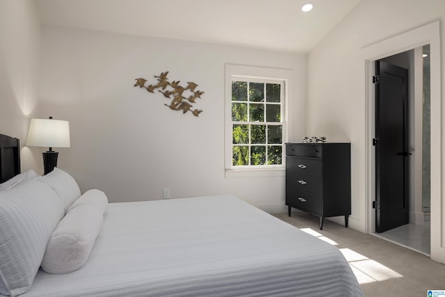 bedroom featuring vaulted ceiling and carpet