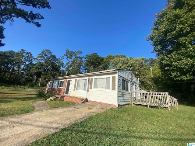 view of side of property with a lawn