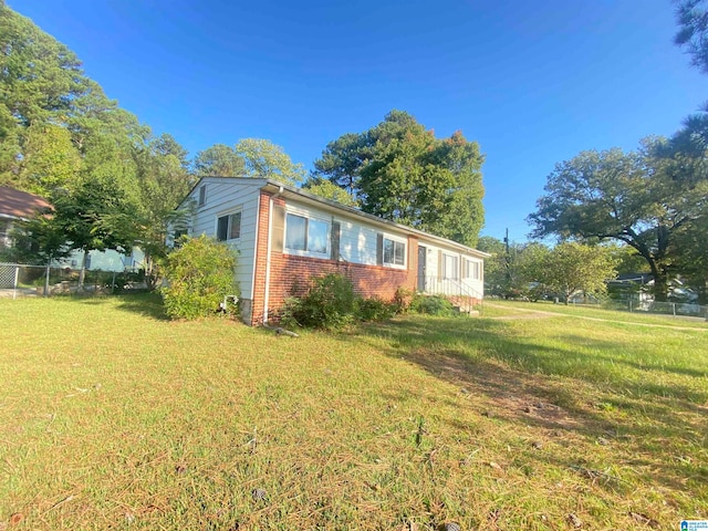 view of side of property featuring a yard