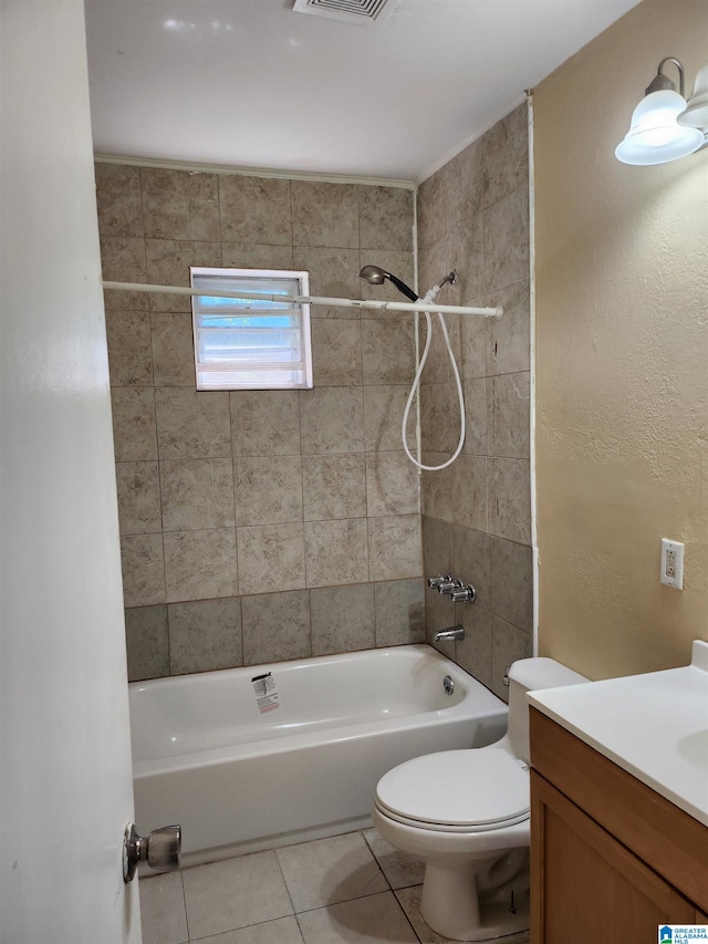 full bathroom with tile patterned flooring, vanity, tiled shower / bath combo, and toilet