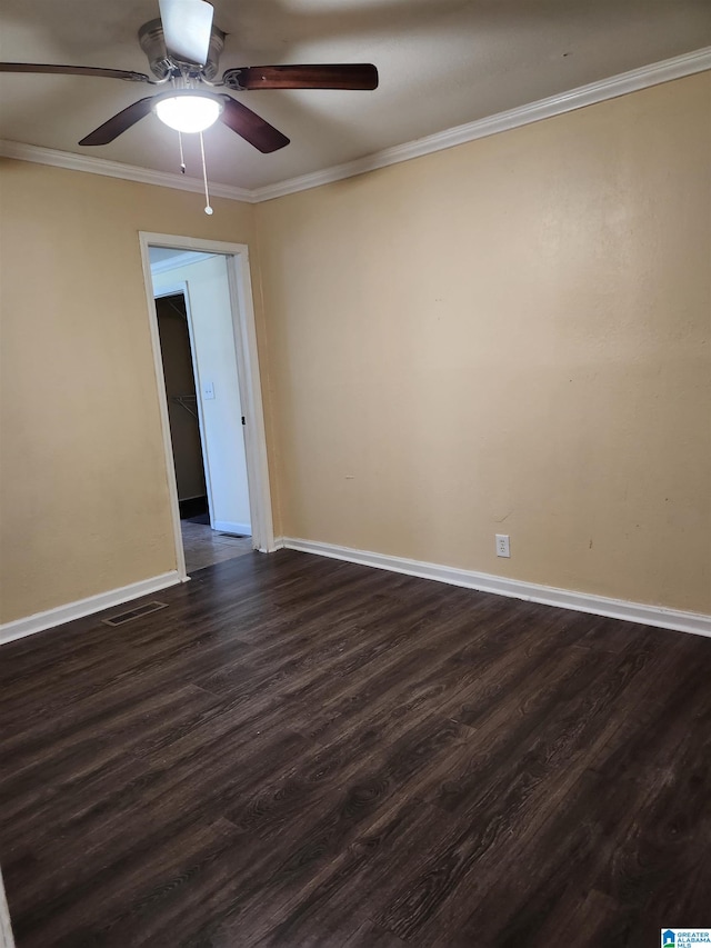 unfurnished room with dark hardwood / wood-style floors, ceiling fan, and crown molding