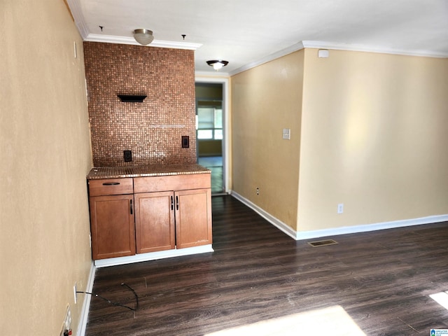 kitchen featuring decorative backsplash, dark hardwood / wood-style flooring, and crown molding