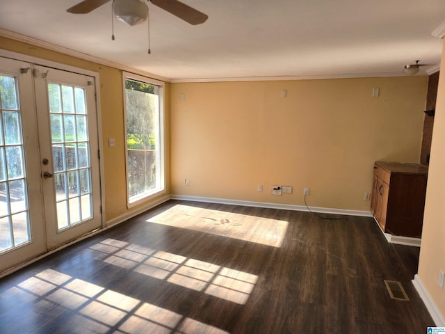 unfurnished room with plenty of natural light, dark hardwood / wood-style floors, ornamental molding, and french doors