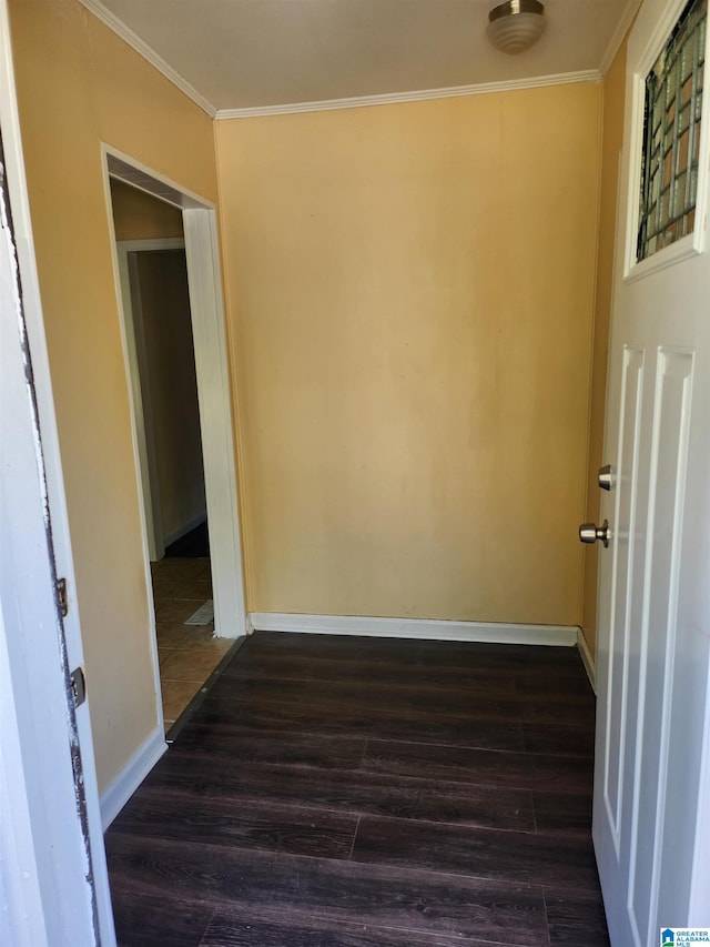 interior space with dark hardwood / wood-style floors and ornamental molding