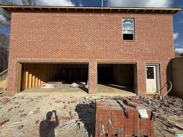 view of side of property with a garage and brick siding