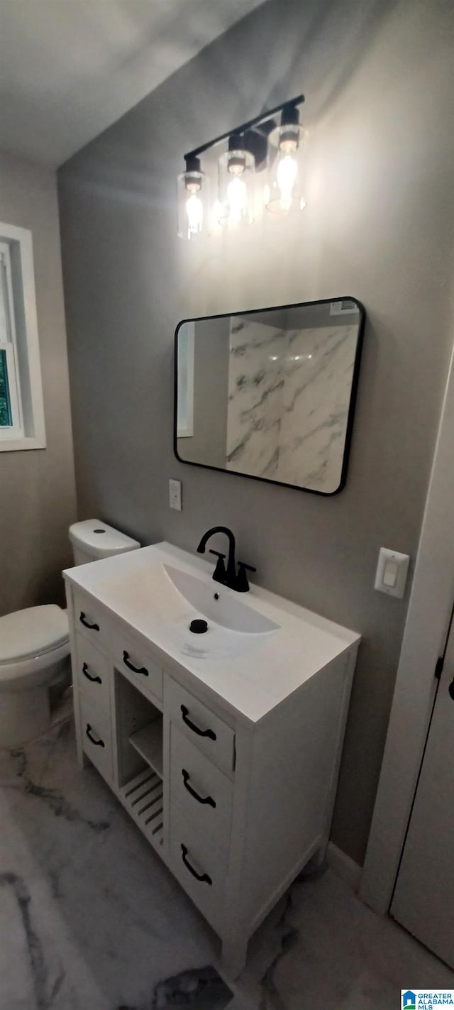 bathroom featuring vanity and toilet