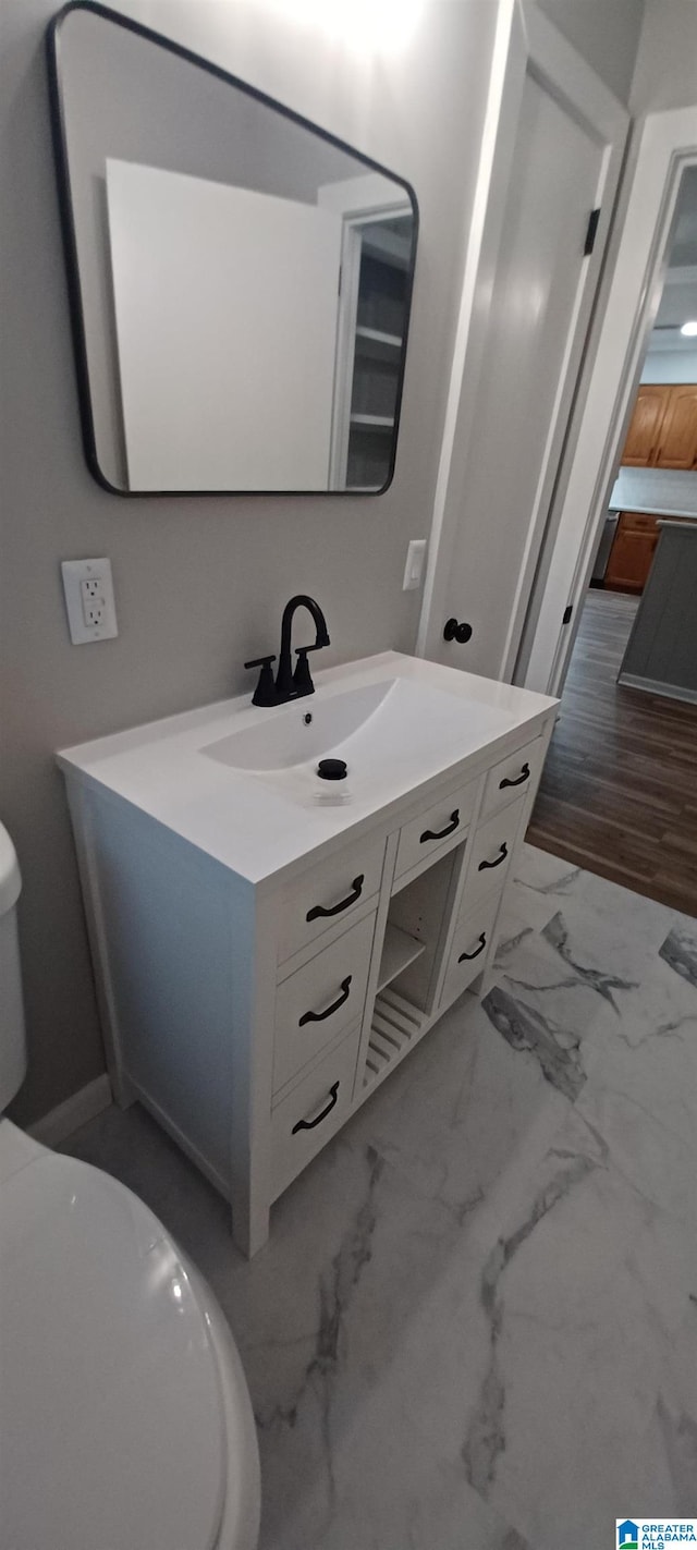 bathroom with vanity and toilet