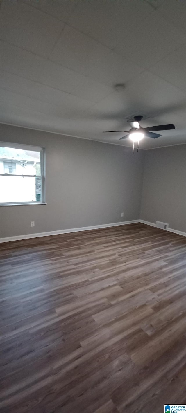 spare room with ceiling fan and dark hardwood / wood-style flooring