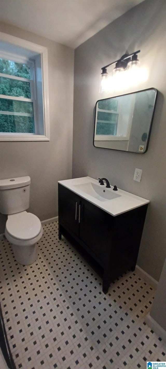 bathroom with vanity, tile patterned floors, and toilet