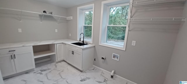 clothes washing area with cabinets, washer hookup, hookup for a gas dryer, and sink