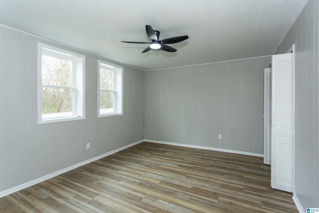 unfurnished room with hardwood / wood-style floors and ceiling fan