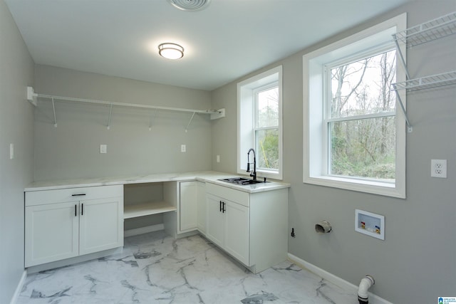 clothes washing area with sink, hookup for a washing machine, and hookup for a gas dryer