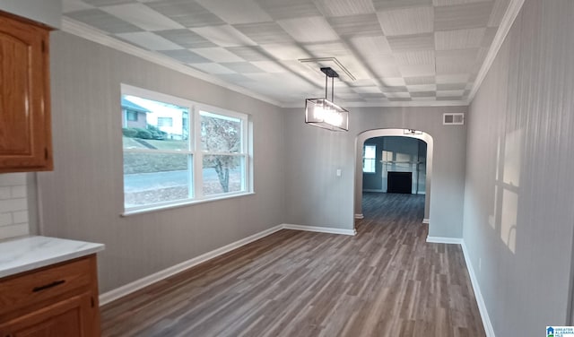 unfurnished dining area with crown molding and wood-type flooring