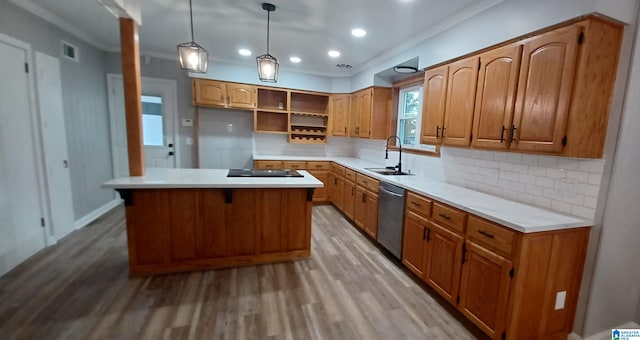 kitchen featuring sink, decorative light fixtures, a center island, light hardwood / wood-style flooring, and stainless steel dishwasher