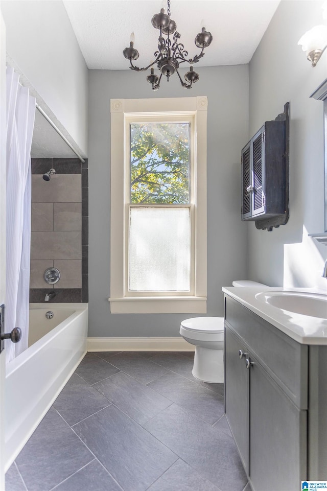 full bathroom featuring shower / bath combination with curtain, vanity, a chandelier, tile patterned floors, and toilet