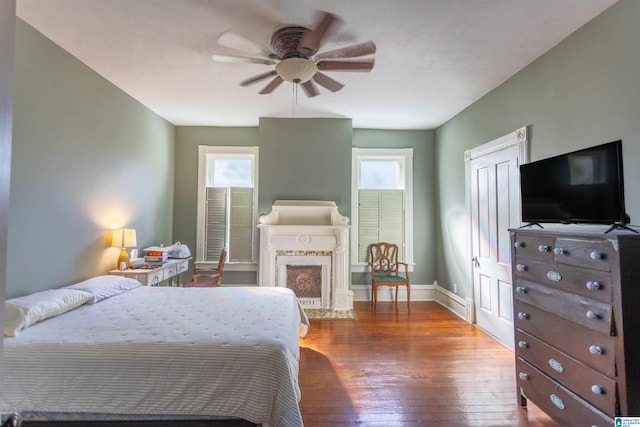 bedroom featuring hardwood / wood-style flooring and ceiling fan