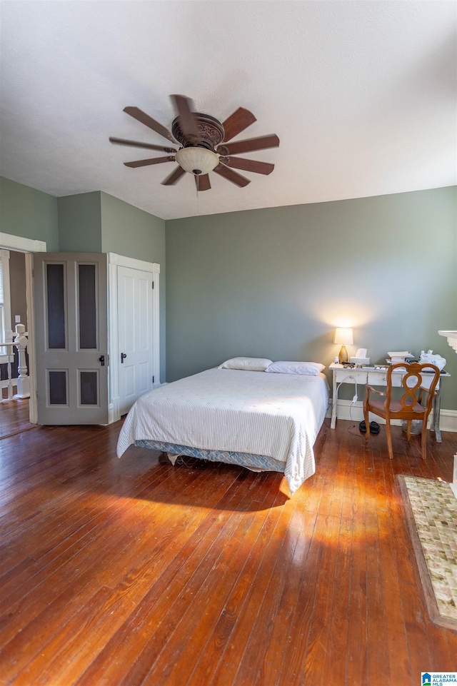 bedroom featuring ceiling fan and dark wood-type flooring