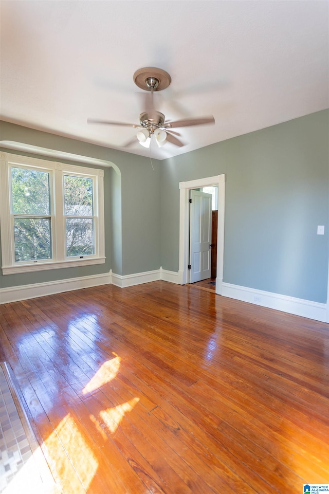 spare room with ceiling fan and hardwood / wood-style flooring