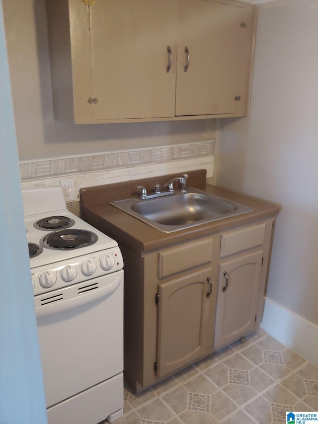 kitchen featuring light tile patterned floors, white range with electric cooktop, and sink