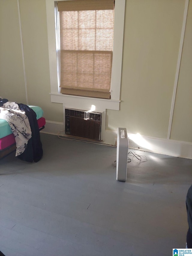 unfurnished bedroom with radiator heating unit and concrete flooring