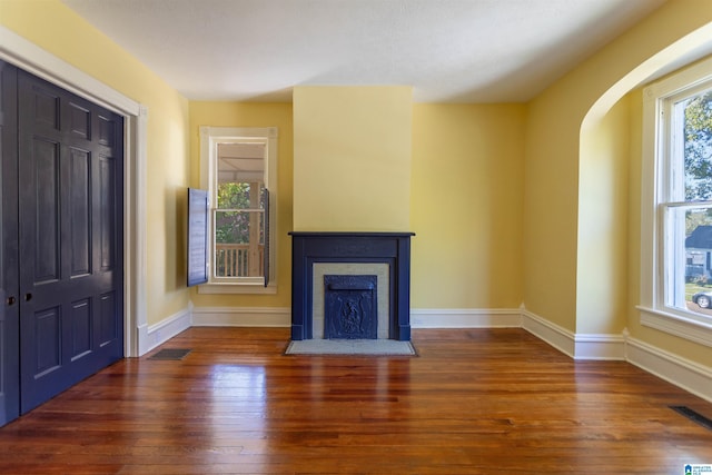 unfurnished living room featuring dark wood-type flooring