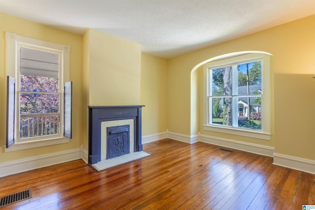 unfurnished living room with wood-type flooring