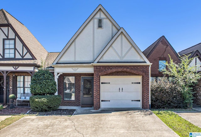 tudor-style house featuring a garage