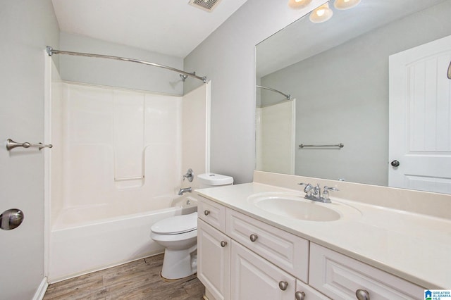 full bathroom with vanity, hardwood / wood-style floors, toilet, and shower / washtub combination