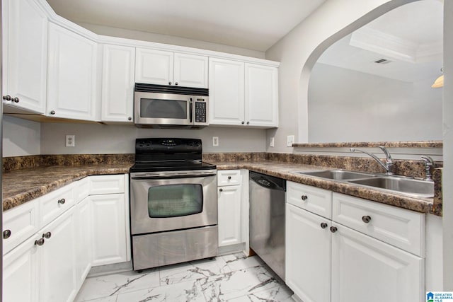 kitchen featuring stainless steel appliances, sink, and white cabinetry