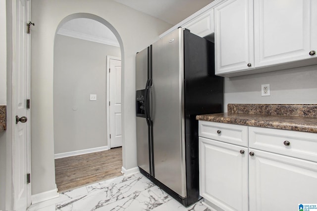 kitchen with white cabinets, stainless steel fridge, light hardwood / wood-style floors, and crown molding