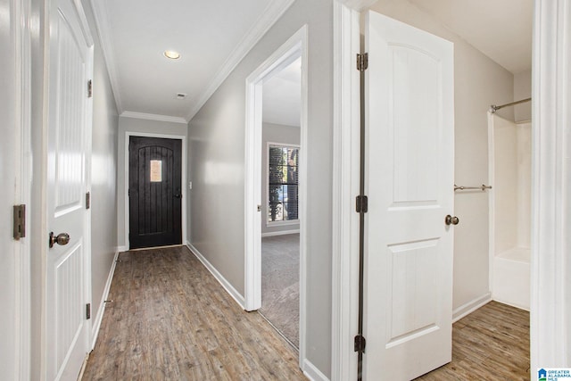 interior space with crown molding and light hardwood / wood-style flooring