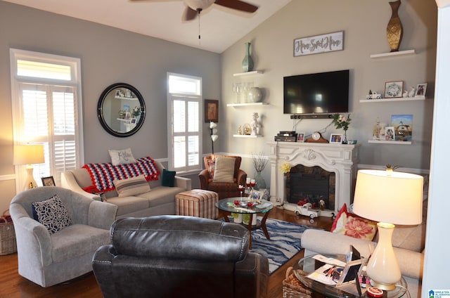 living room with lofted ceiling, wood-type flooring, and ceiling fan