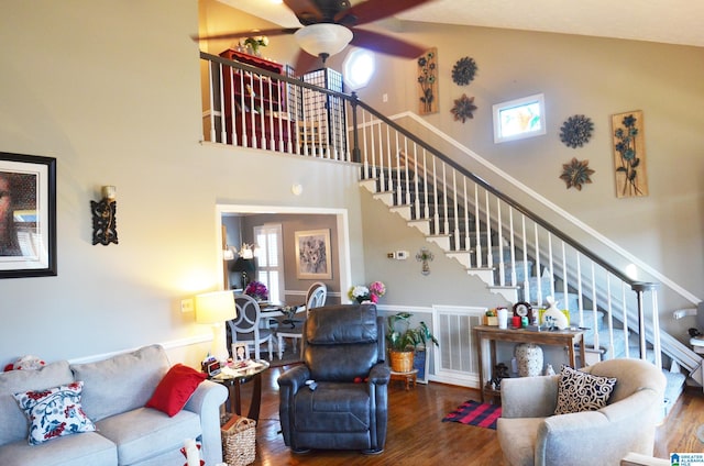 living room featuring high vaulted ceiling, ceiling fan, and wood-type flooring